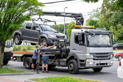 gray-tow-truck-roadway-with-hooked-pickup-truck-two-operators.jpg