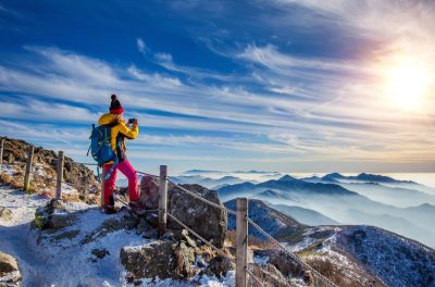 young-woman-hiker-taking-photo-with-smartphone-mountains-peak-winter (1).jpg